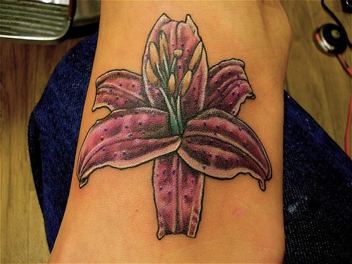 Lily tattoos have a variety of meanings; white petals have come to mean 