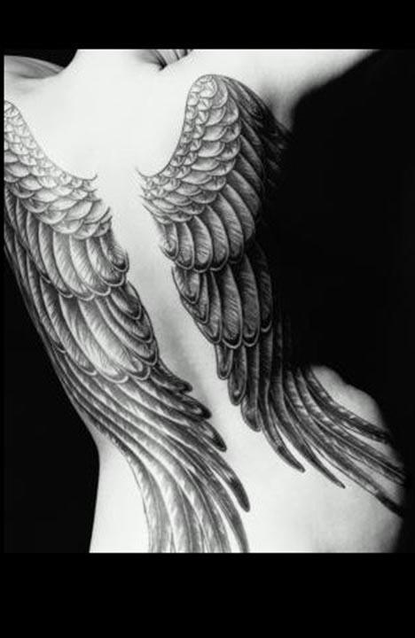 Up and down her spine tattoo-038. Angel wing tattoos appear as back pieces, 